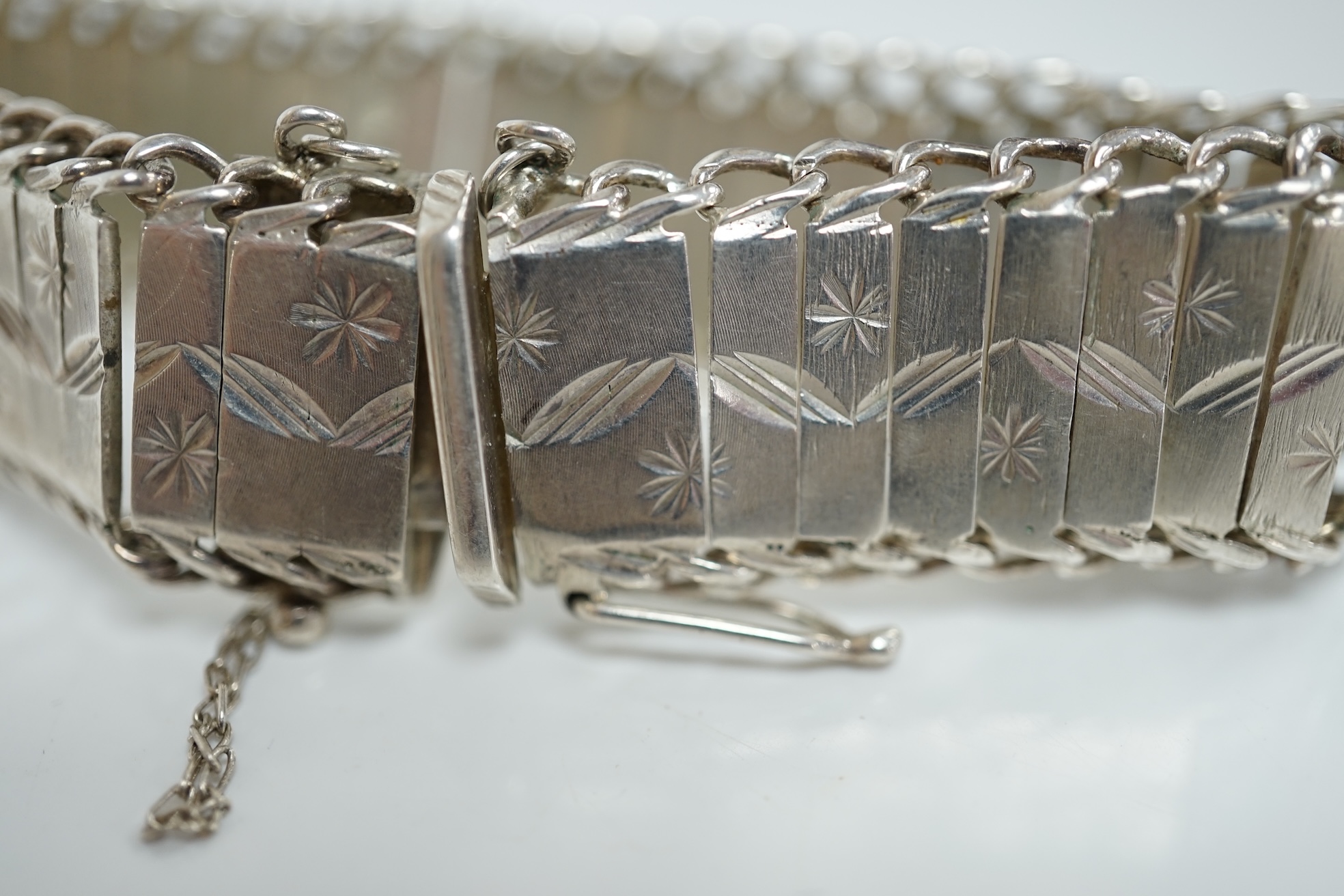 A cased modern silver 'Just a Thimbleful' thimble, 54mm, together with four assorted silver dressing table items and a whit metal bracelet. Condition - fair